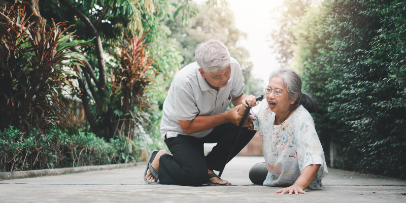 Old Adult Man helping older women up after a fall