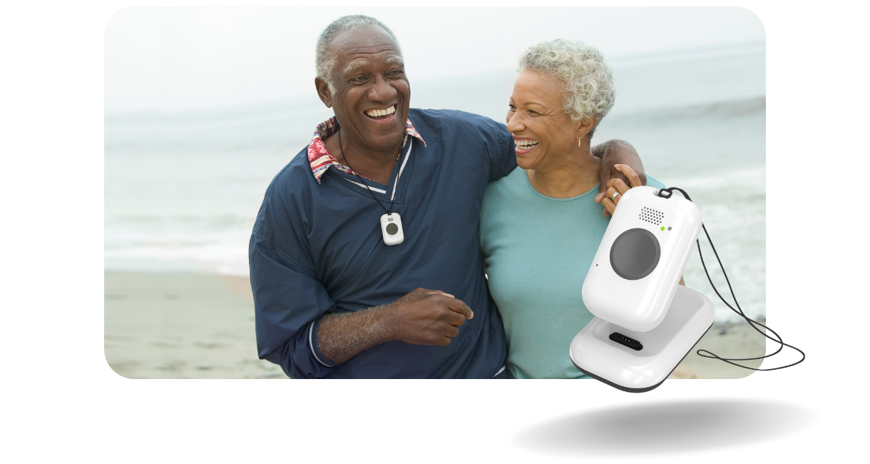 older man on the beach with a woman wearing a lifeline on the go button