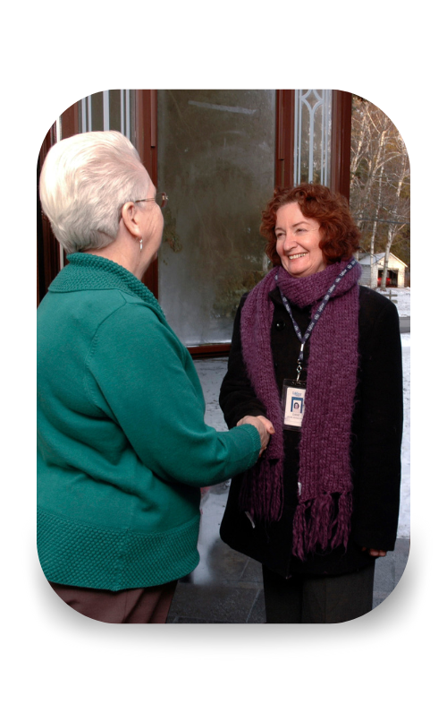 Home Service Representative from Lifeline shaking hands with a client in their home.