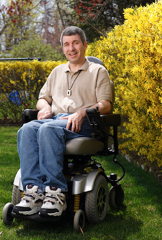 man-in-wheelchair Younger man in a wheelchair wearing a Home Safe neck buton.