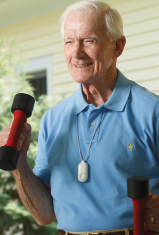 Man wearing the AutoAlert fall detection button while exercising lifting light weights.