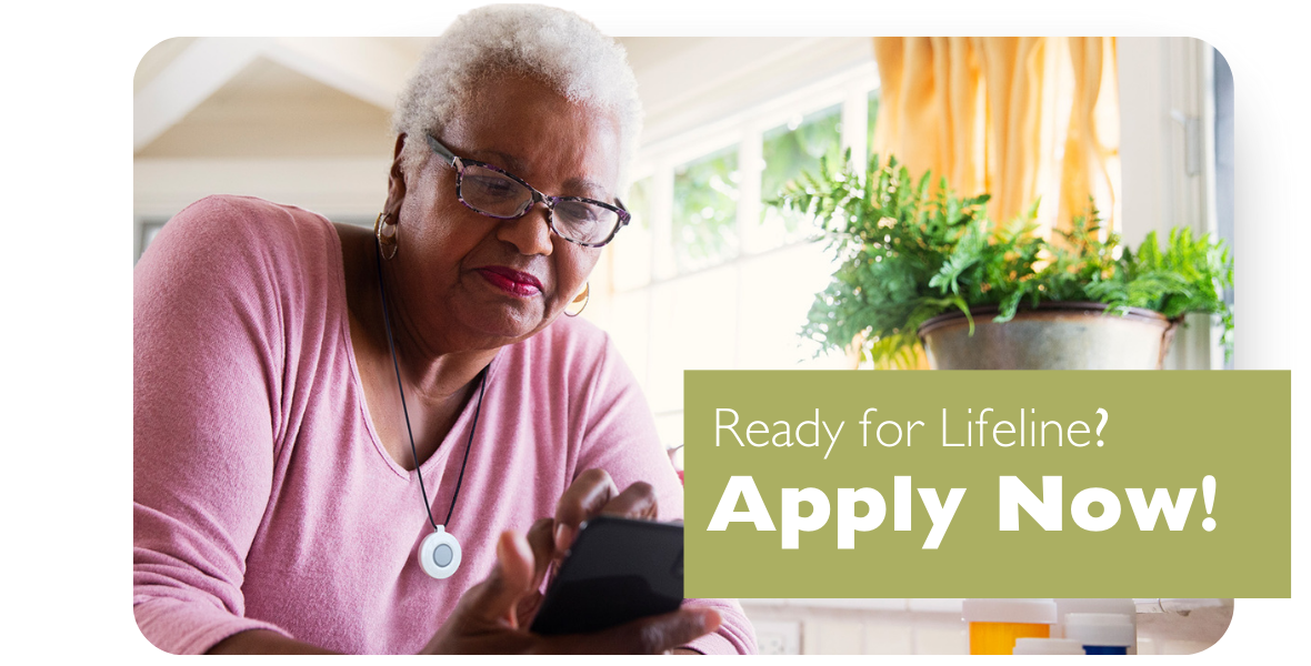 Women wearing lifeline button applying on her phone