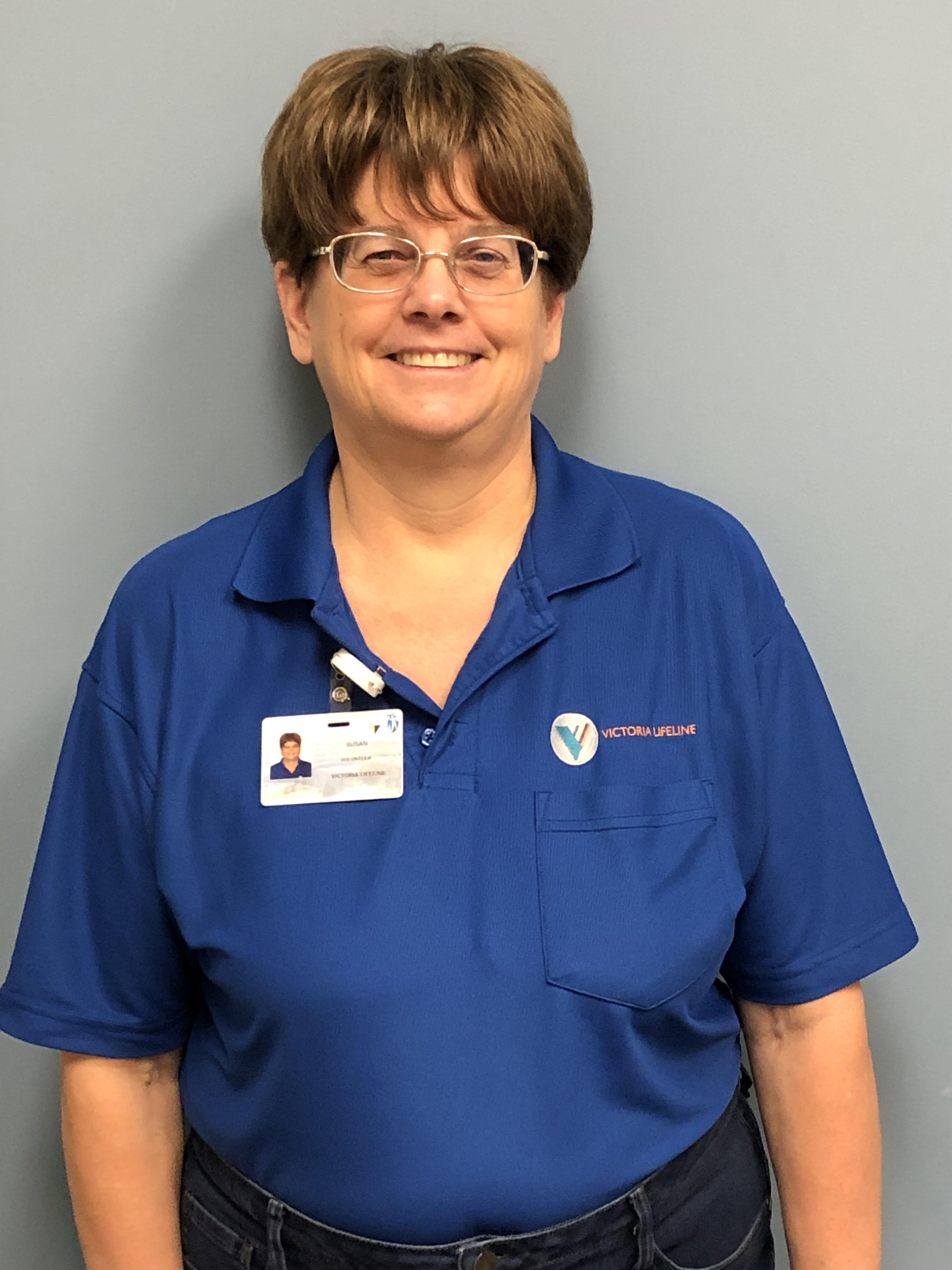 Susan-Dewalt Lifeline volunteer Susan wearing a blue Lifeline shirt and ID badge.