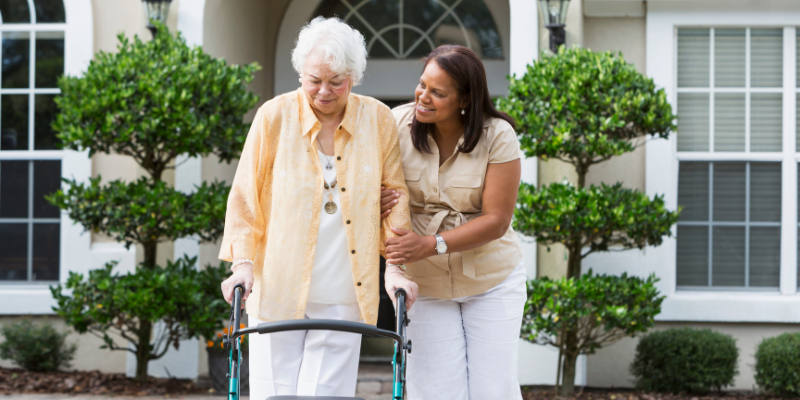 What is a caregiver? Caregiver walking with older women